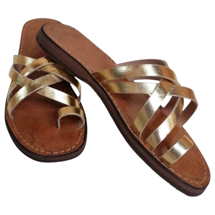 The Window, Milford Haven handmade gold leather sandals with crossed straps and a comfortable flat sole.