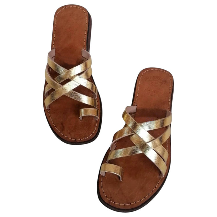 The Window, Milford Haven handmade gold leather sandals with crossed straps and a comfortable flat brown sole.