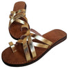 The Window, Milford Haven handmade gold leather sandals with crossed straps and a comfortable flat brown sole.
