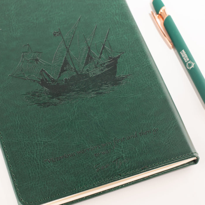 The Window, Milford Haven green leather-effect notebook featuring a galleon ship embossment and Sun Tzu quote.
