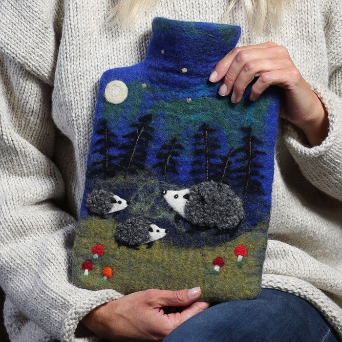 The Window, Milford Haven Black Yak wool felt hot water bottle featuring a hedgehog forest scene at night