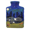 The Window, Milford Haven Black Yak wool felt hot water bottle featuring a blue night forest scene with hedgehogs.
