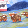 The Window, Milford Haven Black Yak wool felt hot water bottle cover featuring a hand-stitched Highland cow design.