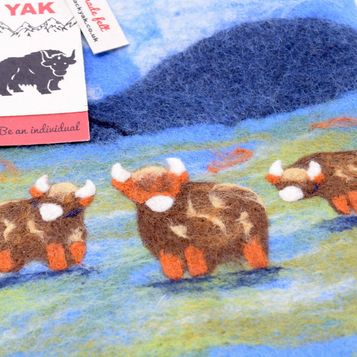 The Window, Milford Haven Black Yak wool felt hot water bottle cover featuring a hand-stitched Highland cow design.