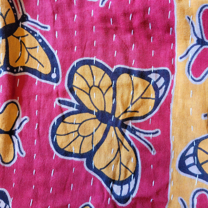 The Window, Milford Haven quilted cotton dressing gown fabric featuring yellow butterfly motifs on red and gold