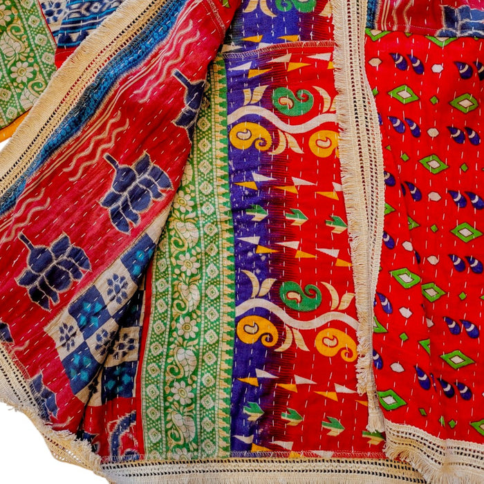 The Window, Milford Haven red and navy Kantha cotton kimono with wide sleeves, intricate quilting, and fringed trim.