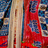 The Window, Milford Haven red and navy cotton Kantha kimono with wide sleeves and a detailed cream fringed border.