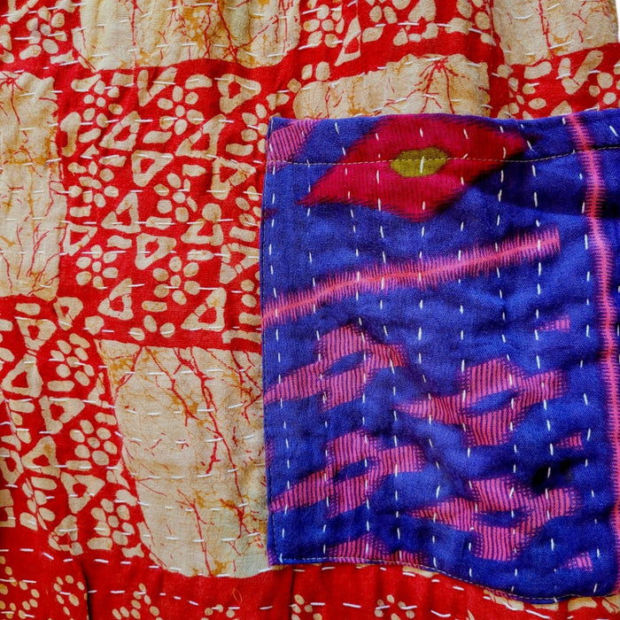 The Window, Milford Haven red and turquoise cotton Kantha overalls featuring intricate hand-stitched quilting detail.