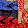 The Window, Milford Haven Kantha cotton overalls featuring red and turquoise patchwork with traditional stitching.