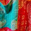 The Window, Milford Haven orange and red Kantha cotton overalls featuring intricate handmade quilting and patterns.