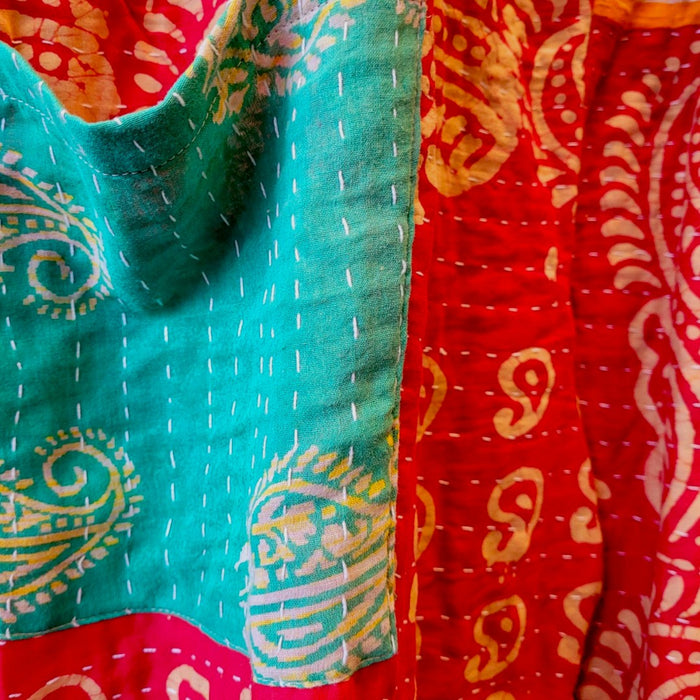 The Window, Milford Haven orange and red Kantha cotton overalls featuring intricate handmade quilting and patterns.