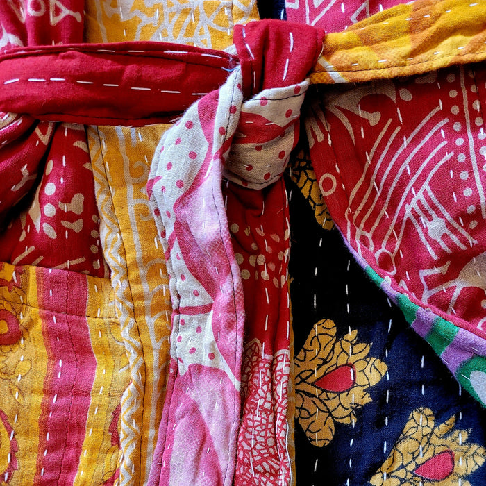 The Window, Milford Haven Kantha quilted cotton dressing gown featuring intricate red, yellow, and black embroidery.