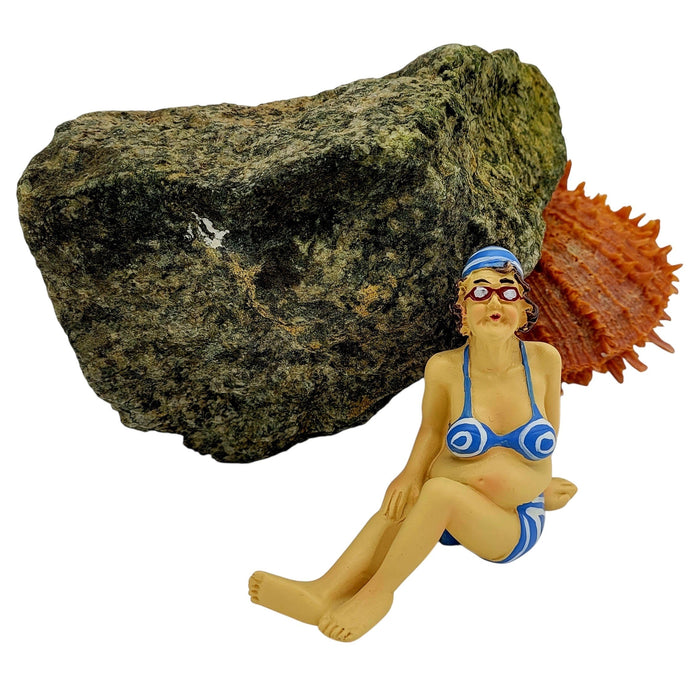 The Window, Milford Haven resin lady sunbather shelf sitter wearing a blue bikini and swim cap sitting by a rock.