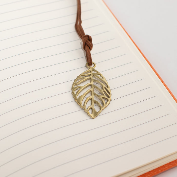 The Window, Milford Haven A5 notebook featuring a brass-coloured leaf bookmark on lined paper with orange cover edge