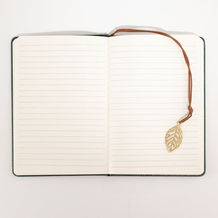The Window, Milford Haven A5 notebook open to lined pages with a brass-coloured leaf bookmark on a brown cord