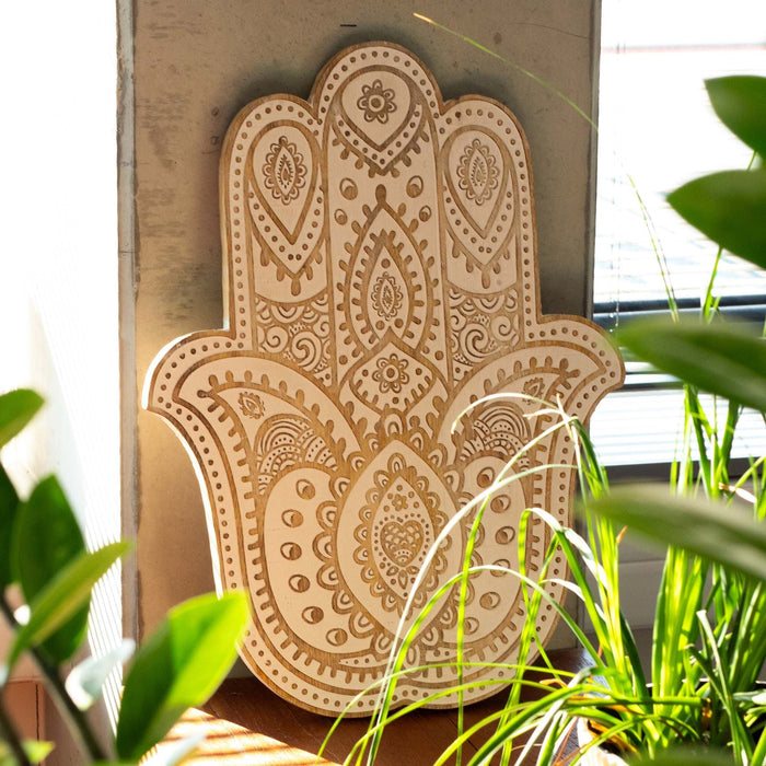 The Window, Milford Haven whitewashed mango wood Hamsa wall plaque with intricate carved bohemian patterns.