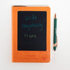 The Window, Milford Haven orange leather-effect A5 notebook with a reusable LCD wipe screen and matching green pen.