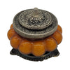 The Window, Milford Haven Patchouli Amber scented soy candle in an orange pumpkin-shaped glass jar with metal lid.