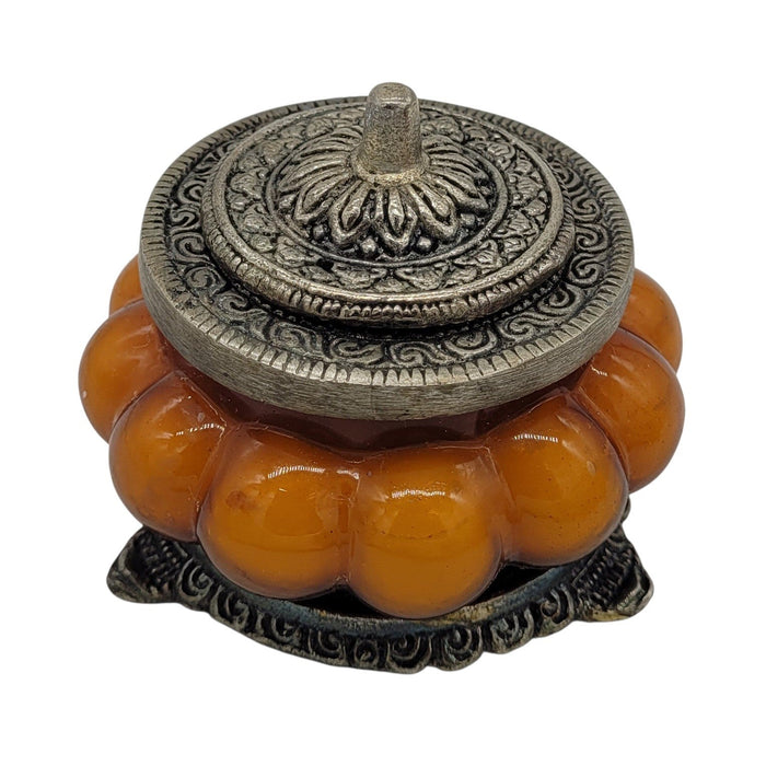 The Window, Milford Haven Patchouli Amber scented soy candle in an orange pumpkin-shaped glass jar with metal lid.