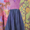 The Window, Milford Haven GRINGO FAIRTRADE smock dress featuring purple, green, and blue panels with floral print.