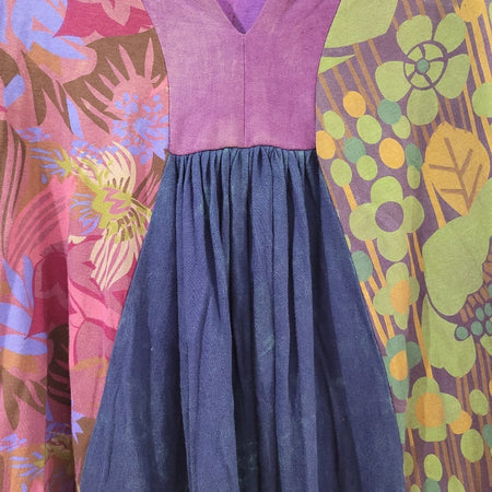 The Window, Milford Haven GRINGO FAIRTRADE smock dress featuring purple, green, and blue panels with floral print.