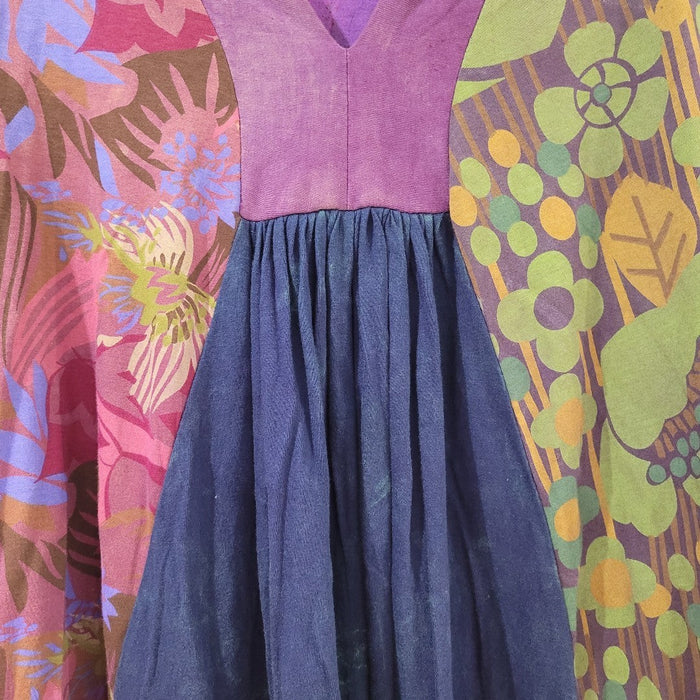 The Window, Milford Haven GRINGO FAIRTRADE smock dress featuring purple, green, and blue panels with floral print.