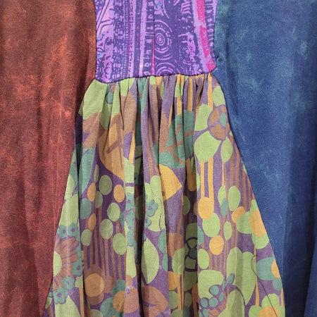 The Window, Milford Haven panelled smock dress featuring brown, purple, blue, and green floral cotton fabric panels.