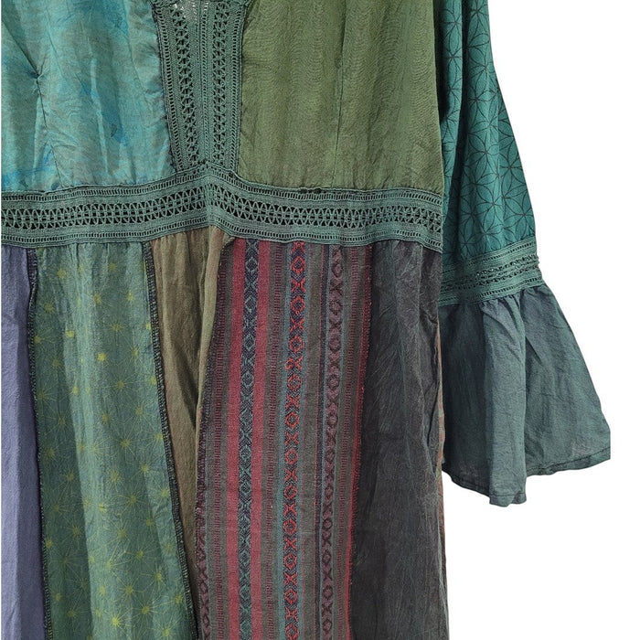 The Window, Milford Haven patchwork cotton midi dress in green and blue tones with lace trim and long flared sleeves.