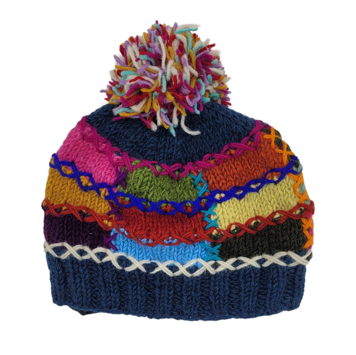 The Window, Milford Haven patchwork wool bobble hat with colourful cross-stitching detail and a multi-coloured pom-pom