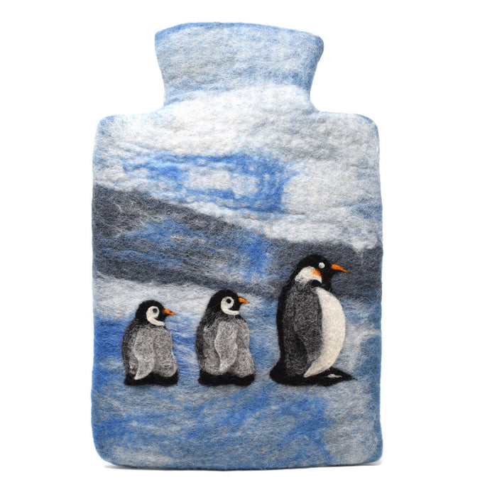 The Window, Milford Haven handmade wool felt hot water bottle cover featuring a blue snowy penguin family design.
