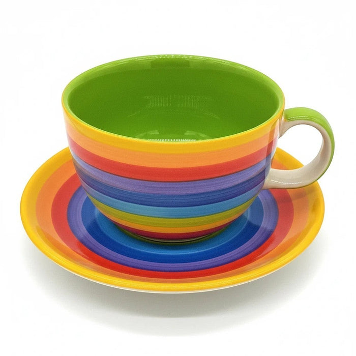 The Window, Milford Haven giant ceramic breakfast cup and saucer with bright hand-painted rainbow stripes.