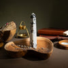 The Window, Milford Haven Rainbow Moonstone six-face obelisk point on a wooden tray with dried lavender.