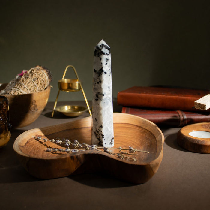 The Window, Milford Haven Rainbow Moonstone six-face obelisk point on a wooden tray with dried lavender.