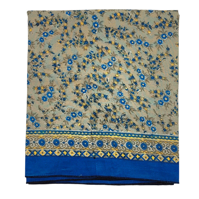 The Window, Milford Haven recycled sari scarf featuring a beige background with blue floral patterns and a blue border.