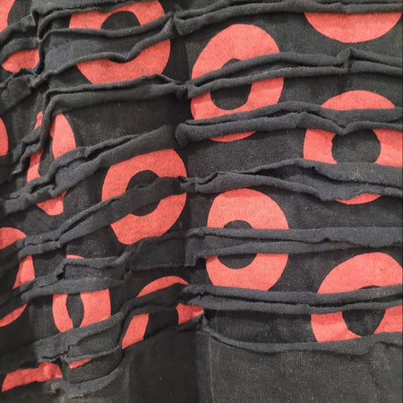 The Window, Milford Haven cotton tunic dress featuring a black and red circle print with textured raw seam detailing.