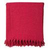 The Window, Milford Haven red and pink striped recycled cotton throw with decorative tasselled fringe edges.