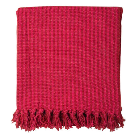 The Window, Milford Haven red and pink striped recycled cotton throw with decorative tasselled fringe edges.