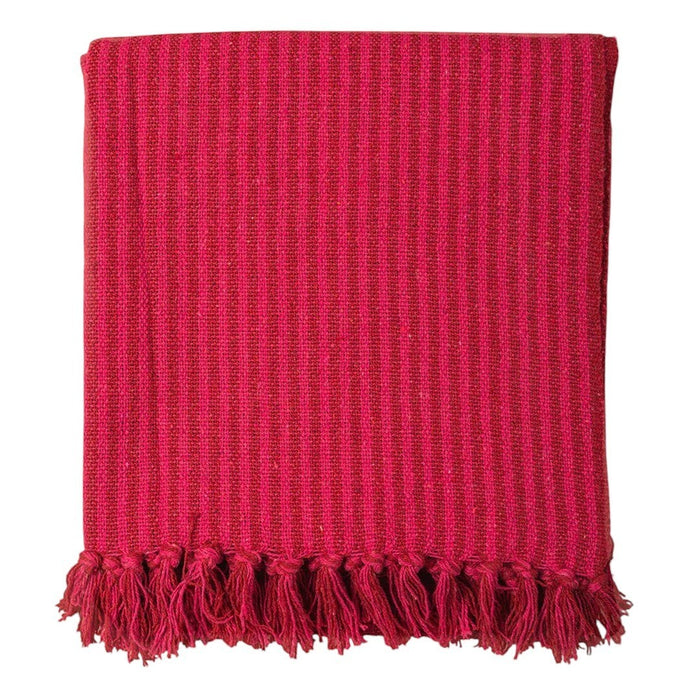 The Window, Milford Haven red and pink striped recycled cotton throw with decorative tasselled fringe edges.