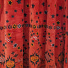 The Window, Milford Haven red velour tunic dress featuring embroidered stars, flowers, and sun motifs.