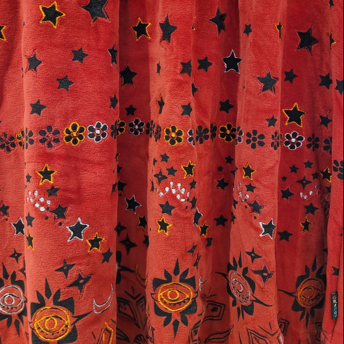 The Window, Milford Haven red velour tunic dress featuring embroidered stars, flowers, and sun motifs.