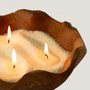 The Window, Milford Haven Regent Polo cream fragranced candle sand burning with three wicks in a rustic wooden bowl.