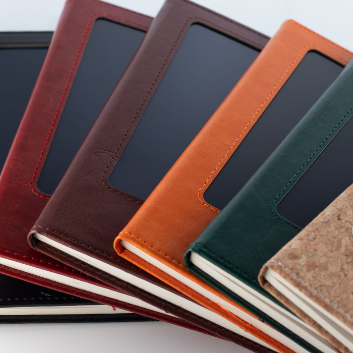 The Window, Milford Haven reusable LCD screen notebooks in various leather-effect colours stacked together