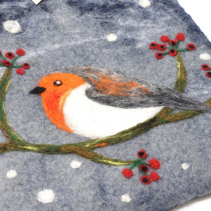 The Window, Milford Haven Black Yak wool felt hot water bottle cover featuring a hand-stitched robin on a snowy branch