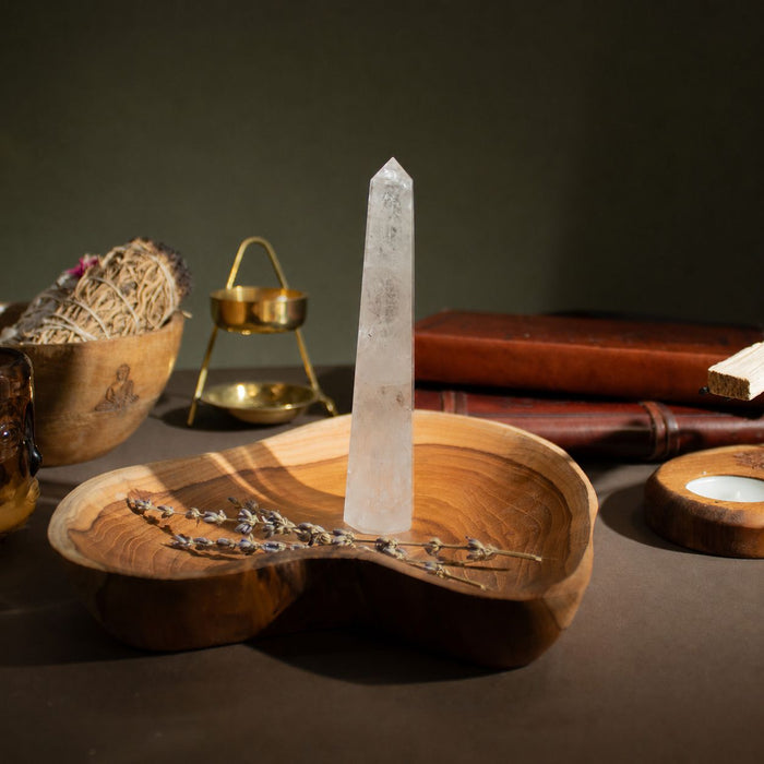 The Window, Milford Haven clear rock crystal six-face obelisk point standing on a wooden dish with dried lavender.