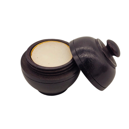 The Window, Milford Haven natural solid perfume in a hand-carved dark rosewood jar with a screw-top lid.