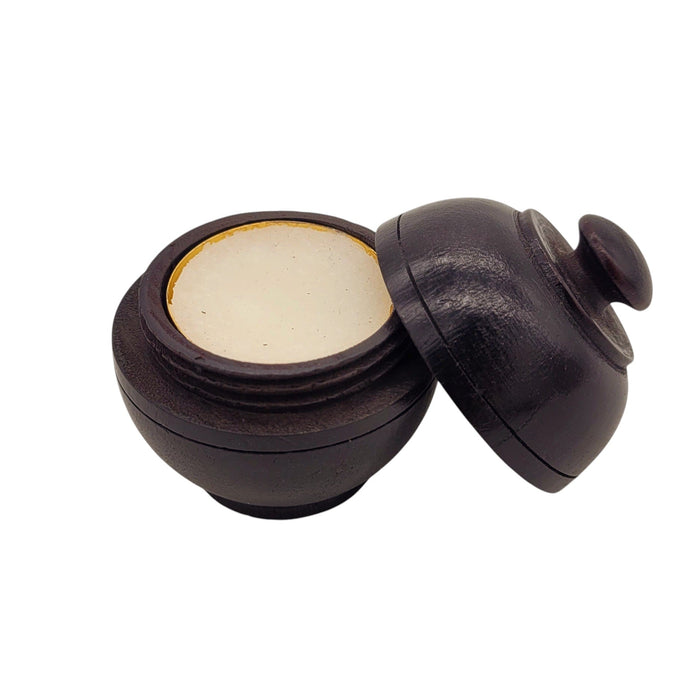 The Window, Milford Haven natural solid perfume in a hand-carved dark rosewood jar with a screw-top lid.