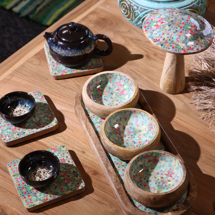 The Window, Milford Haven square mango wood coasters with vibrant Mediterranean tile patterns on a wooden table