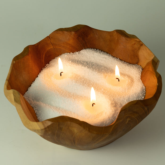 The Window, Milford Haven Starlight Elixir white candle sand burning with three wicks in a rustic wooden bowl