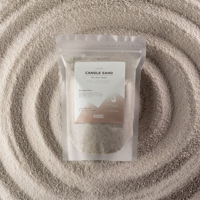The Window, Milford Haven Starlight Elixir fragranced white candle sand in a 300g pouch surrounded by loose wax beads.