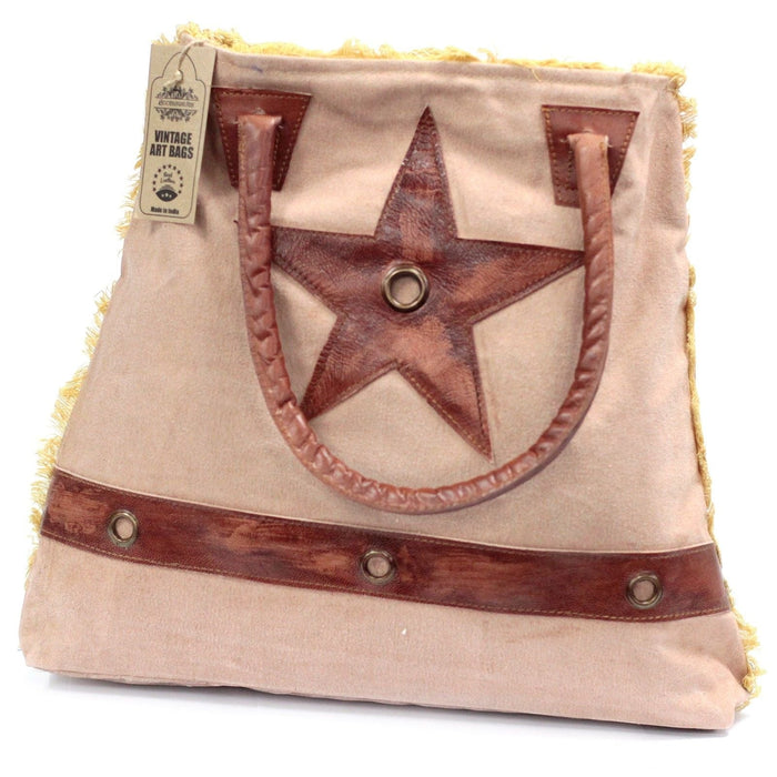 The Window, Milford Haven vintage cotton tote bag with brown leather star applique, handles, and frayed yellow edges.